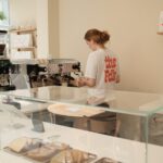 specialty coffee barista steaming fresh milk at The Folk cafe in Odense.