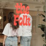 coffee shop owners behind a glass wall with the logo