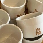customized white coffee cups with the folk logo